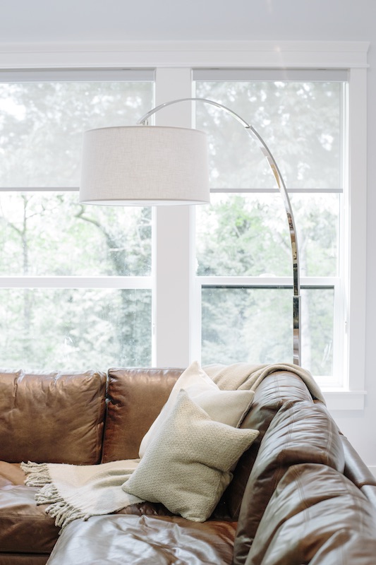 caramel leather sofa with arc lamp